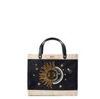 Petite Market Bag in Black with Sun & Moon Bead, front view: gold and pearl beaded sun and crescent moon embroidery with beaded stars on black jute, natural leather label personalized with initials, black leather handles