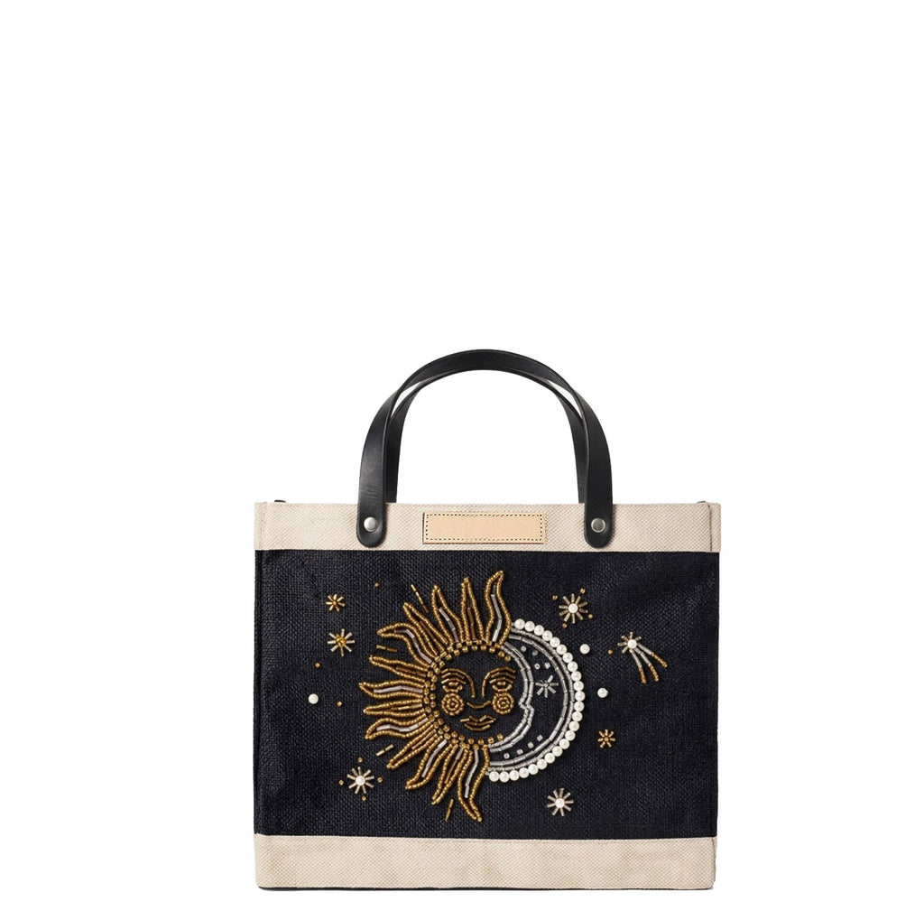 Petite Market Bag in Black with Sun & Moon Bead, front view with blank natural leather label ready for personalization; gold and pearl beaded sun and moon on black jute with black leather handles